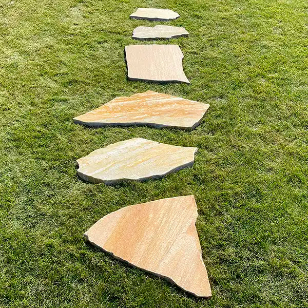 Linear verlegte Quarzit Trittplatten Auralis auf dem Rasen